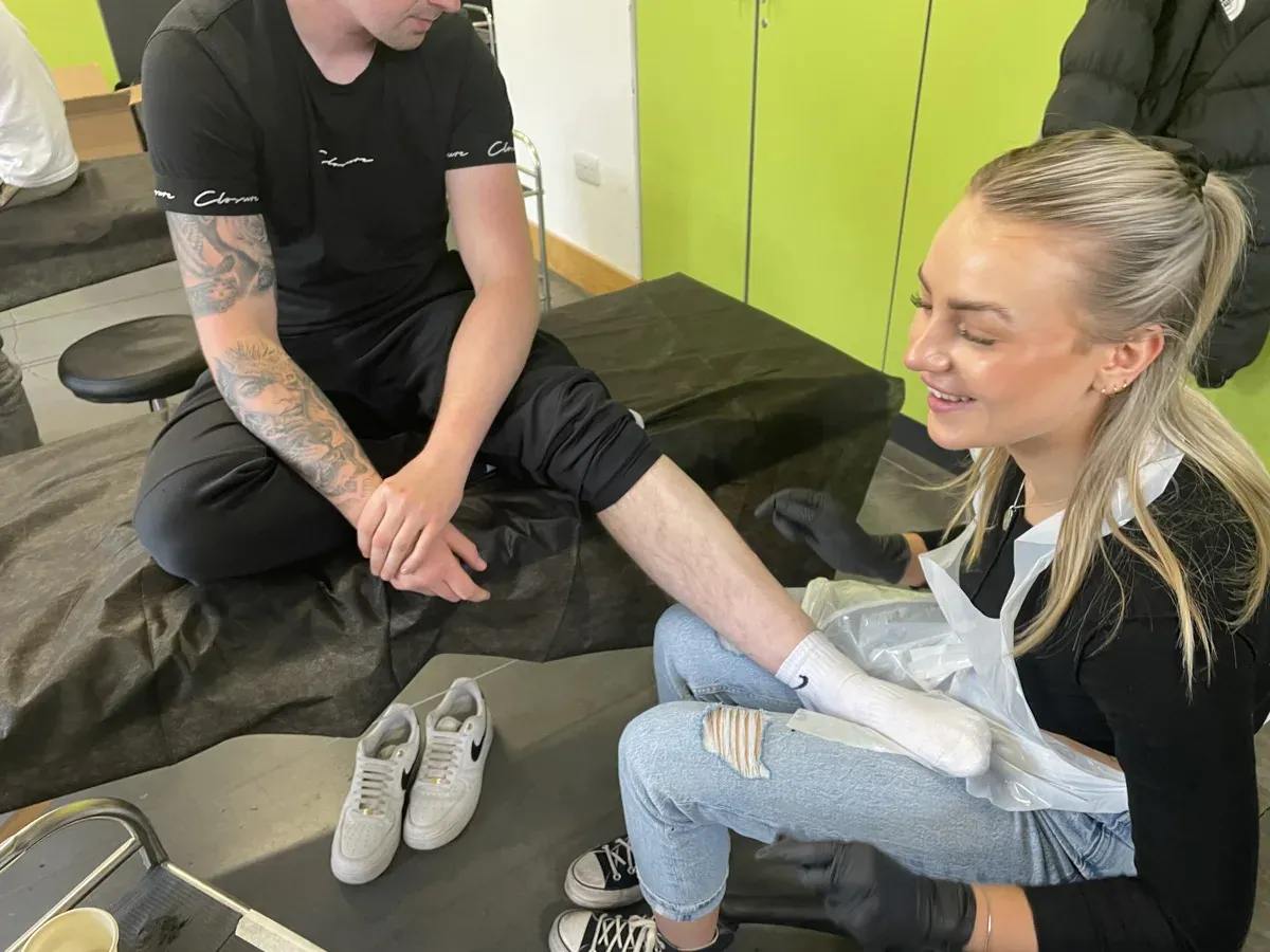 Tutor and student during a tattoo session